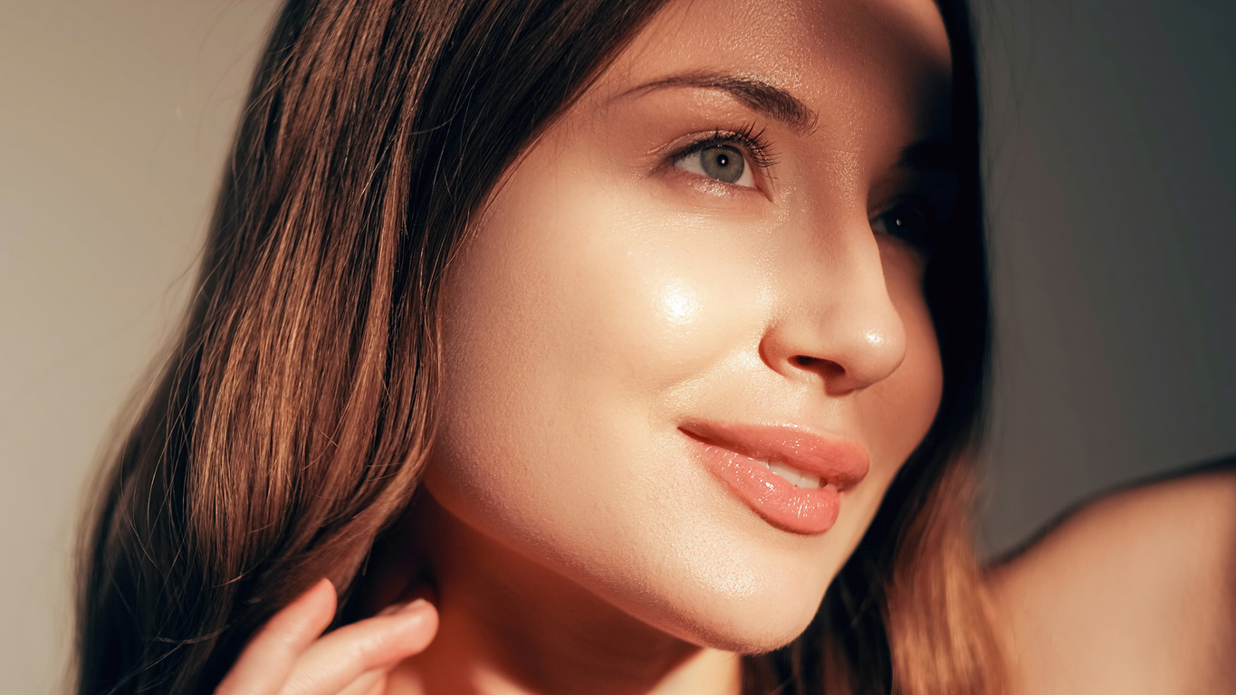 woman with brown hair and glowing face